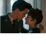 Elvis: a dark haired man and woman looking as if they are about to kiss.